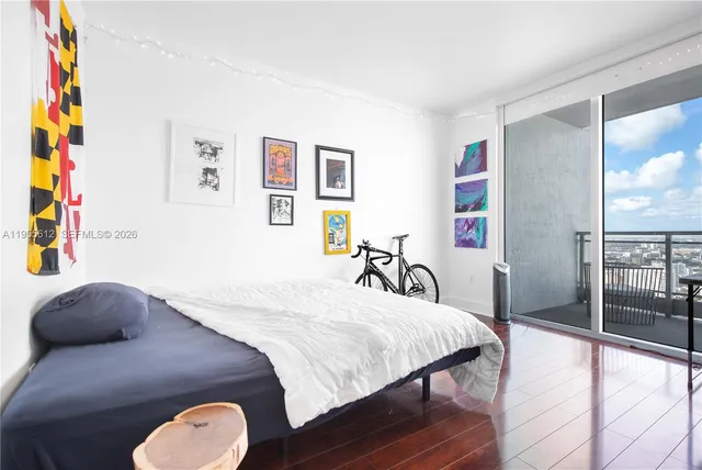 a bedroom with a bed and a painting on the wall