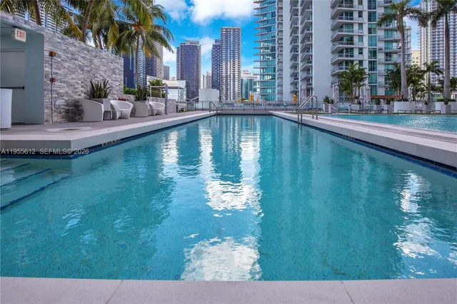 a swimming pool with outdoor seating and yard