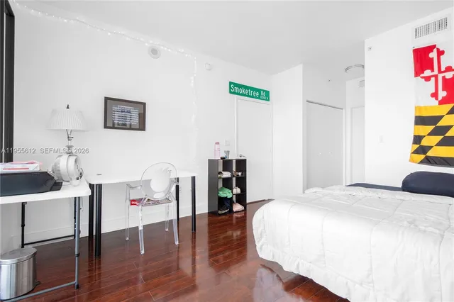 a bedroom with a bed and a table in it