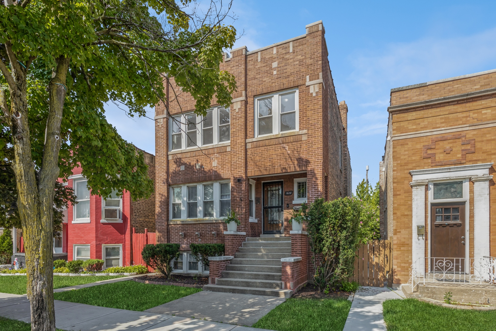a front view of house with yard and green space