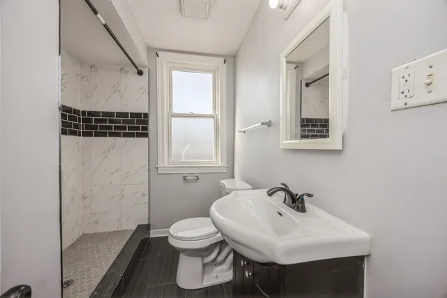 a view of backyard of a house with table and chairs