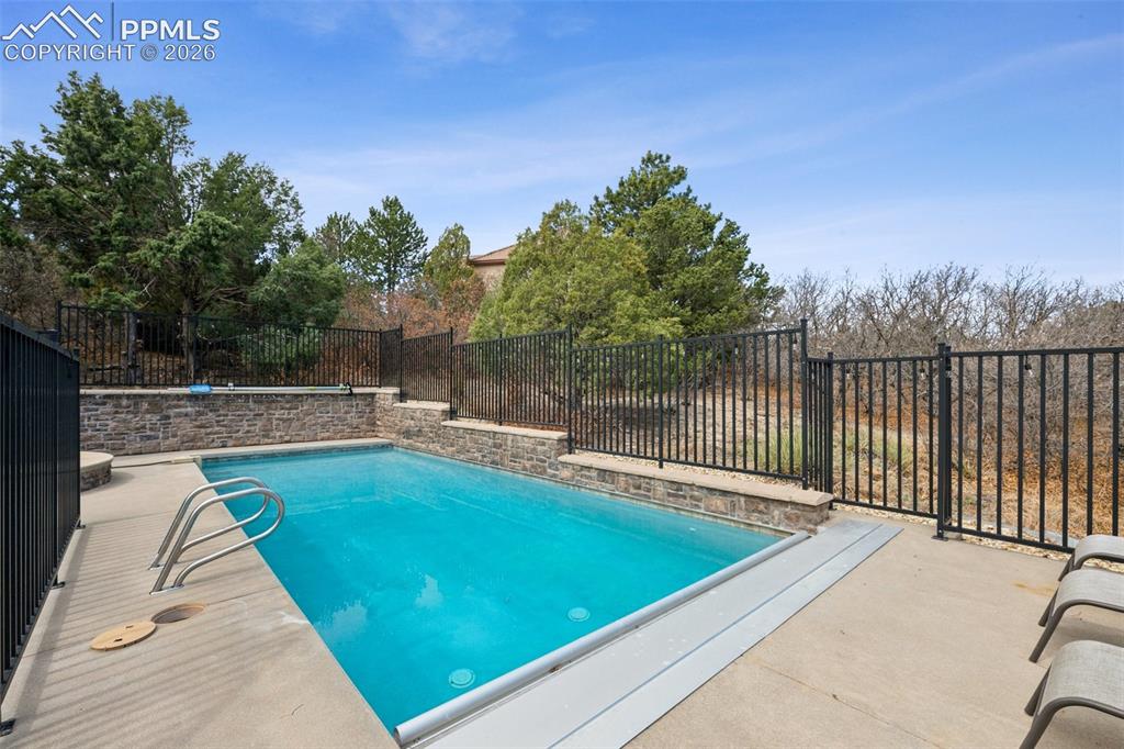 5039 Stonehill Road Colorado Springs, CO 80918 - Photo 48 of 50 View of pool featuring a fenced backyard, a fenced in pool, and a patio