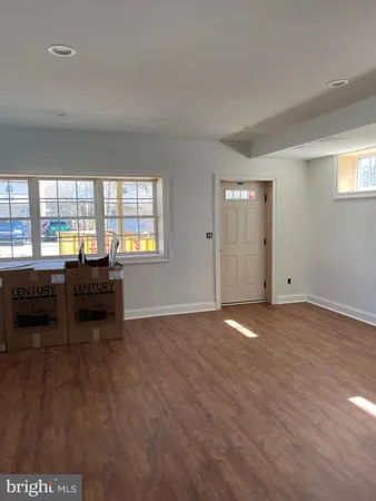 an empty room with piano and wooden floor