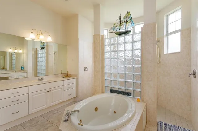 a bathroom with a bathtub sink and mirror