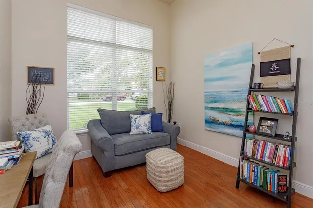 a living room with furniture and a book shelf