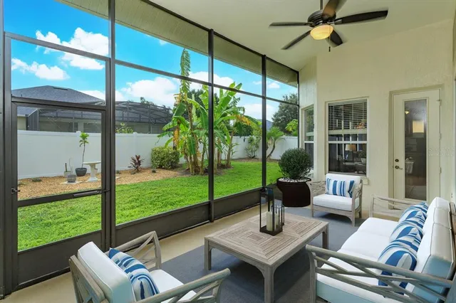 a living room with a floor to ceiling windows and a table