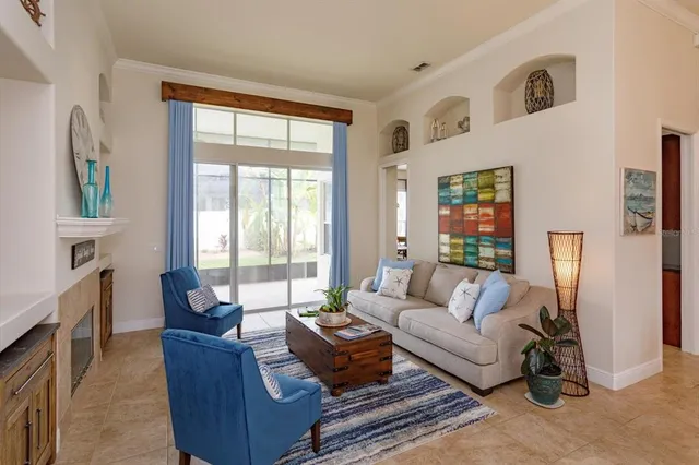 a living room with furniture large window and wooden floor