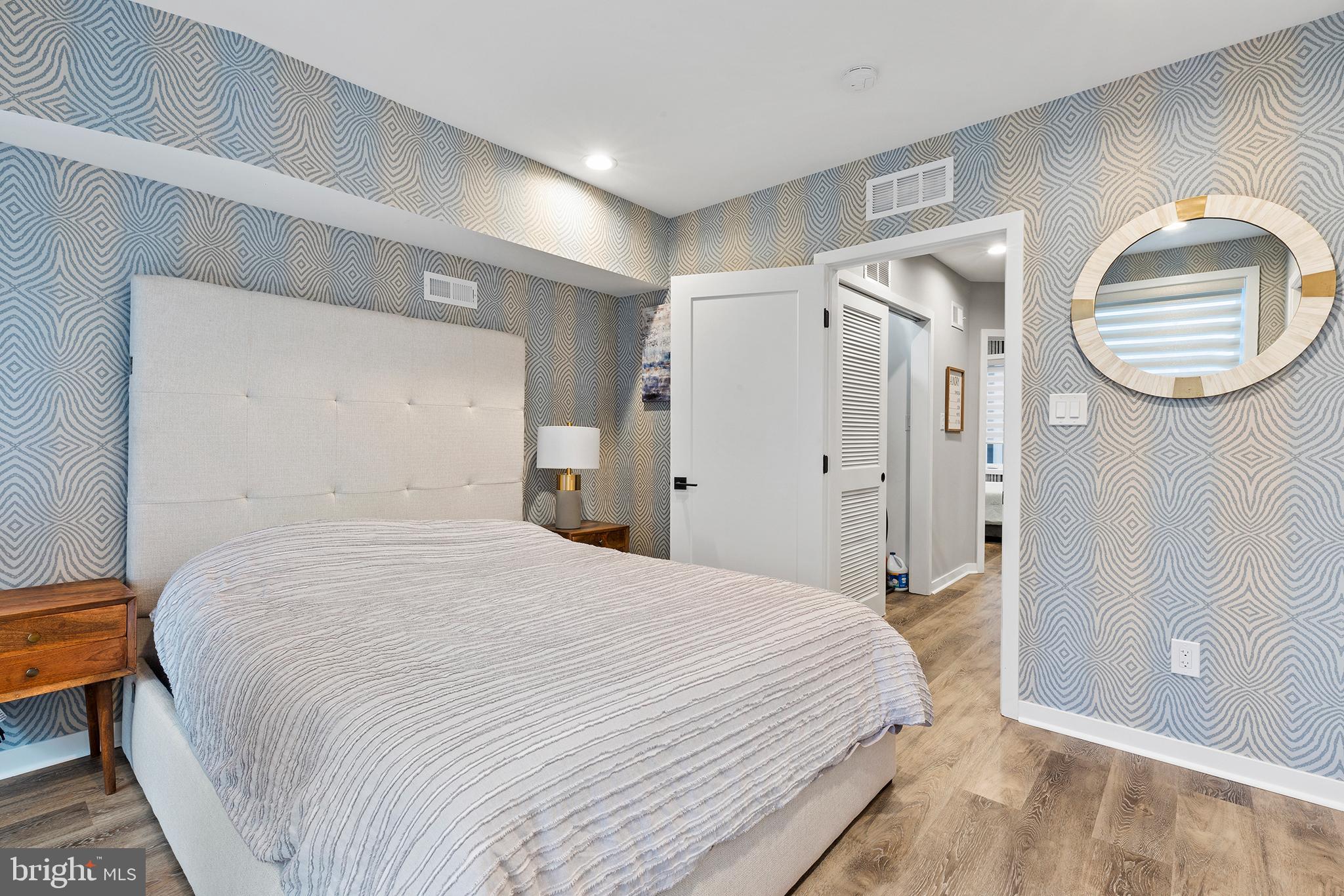 815 Perkiomen Street, Unit 15 Philadelphia, PA 19130 - Photo 12 of 27 a bedroom with a bed and a mirror