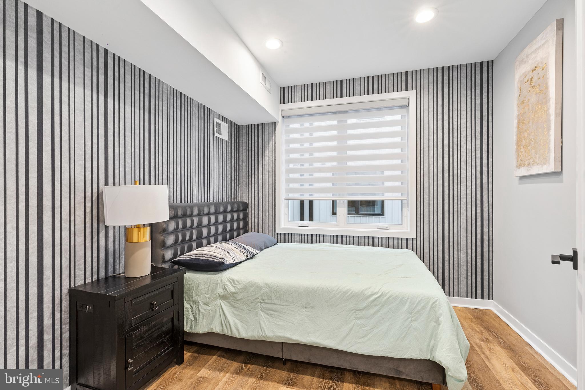 815 Perkiomen Street, Unit 15 Philadelphia, PA 19130 - Photo 14 of 27 a bedroom with a bed and a lamp