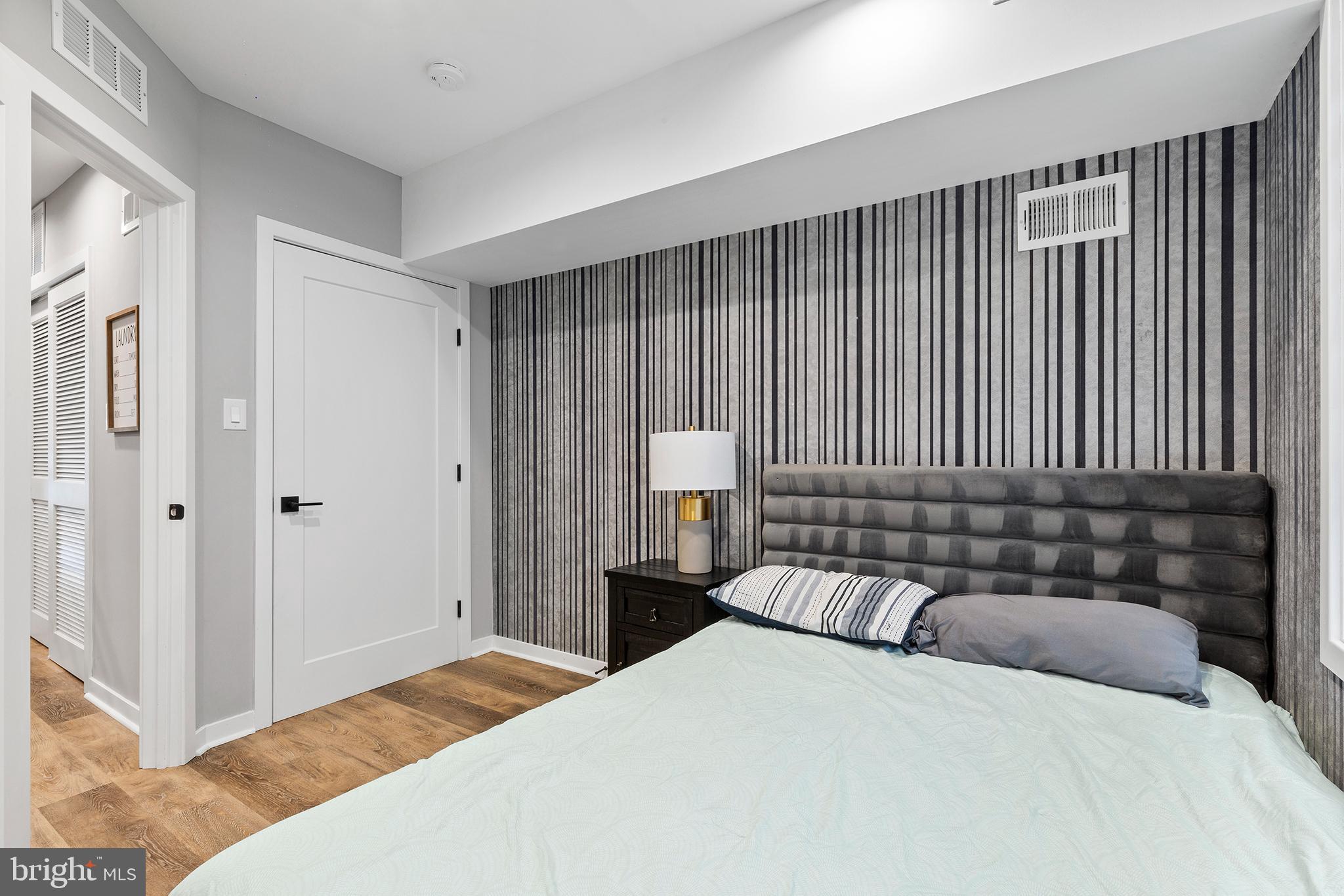 815 Perkiomen Street, Unit 15 Philadelphia, PA 19130 - Photo 15 of 27 a bedroom with a bed and a large mirror