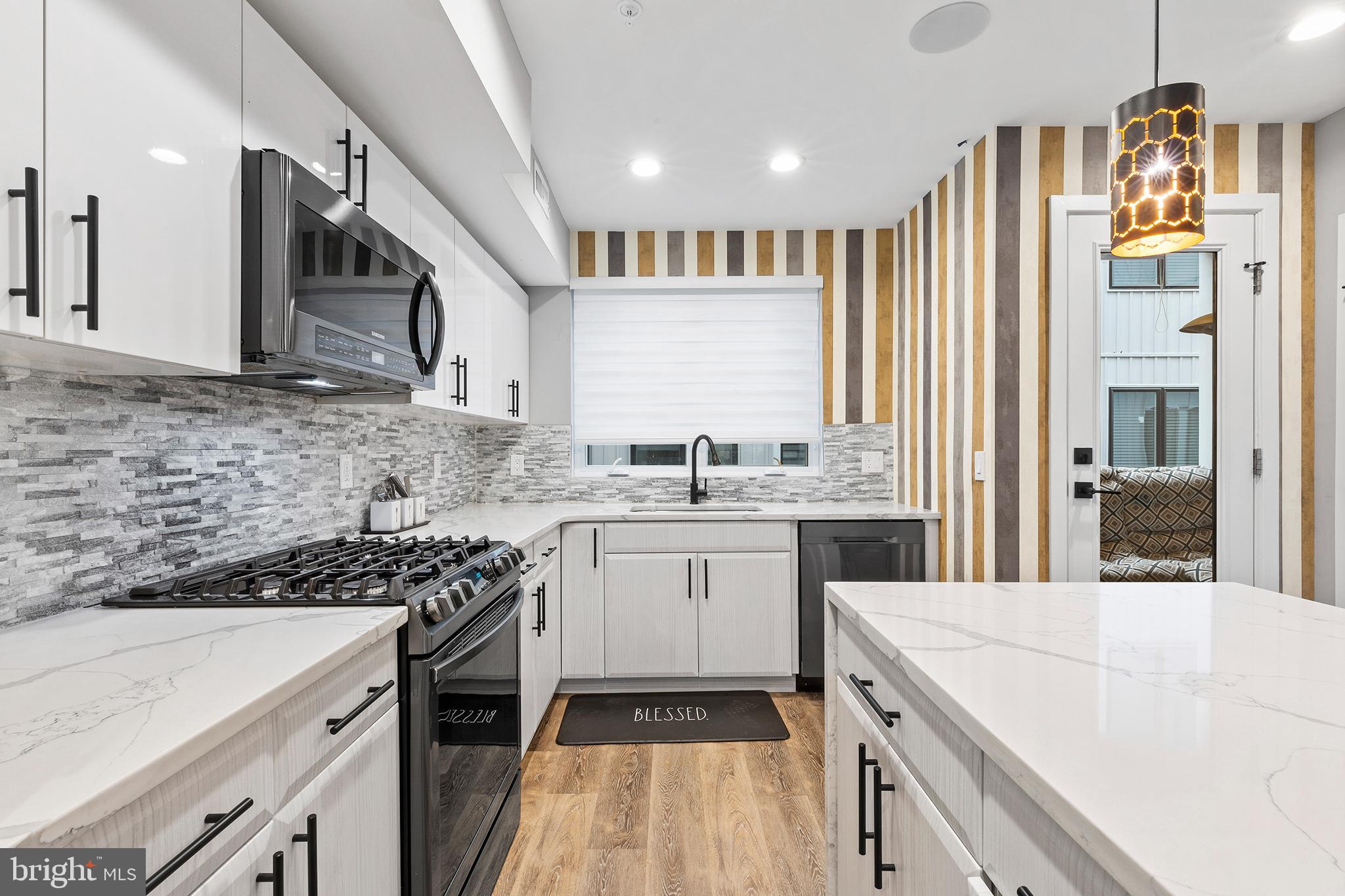 815 Perkiomen Street, Unit 15 Philadelphia, PA 19130 - Photo 8 of 27 a kitchen with a sink stove and cabinets