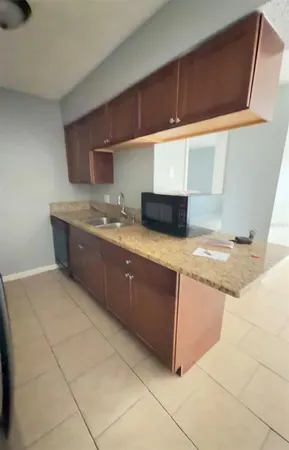 a kitchen with stainless steel appliances granite countertop a sink and a stove