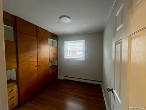 an empty room with wooden floor and closet