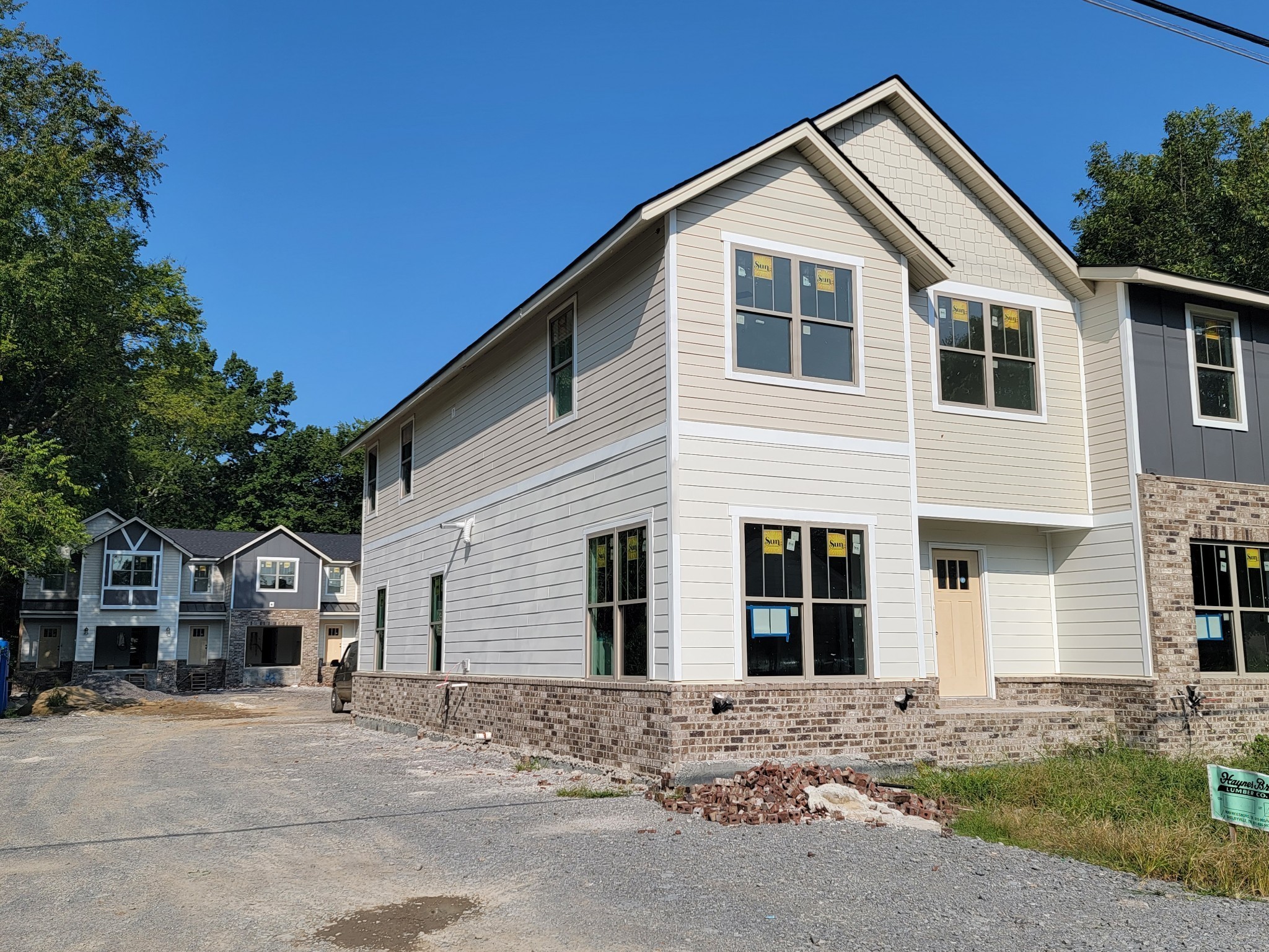 a view of a house with a yard and large tree