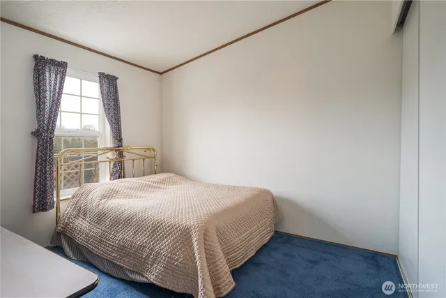 a bedroom with a bed and window