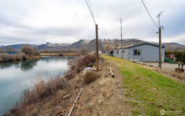 a view of a lake with a house next to a yard
