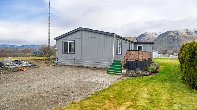 a backyard of a house with barbeque oven and outdoor seating