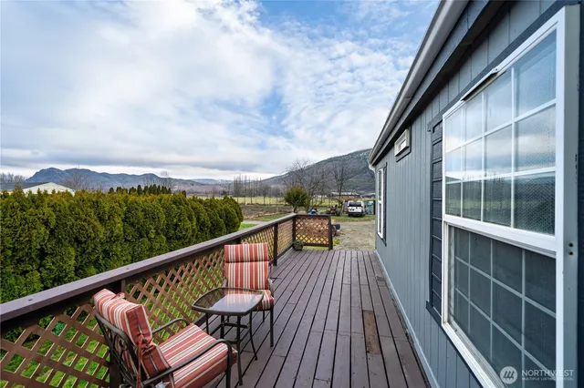 a view of balcony with wooden floor and fence