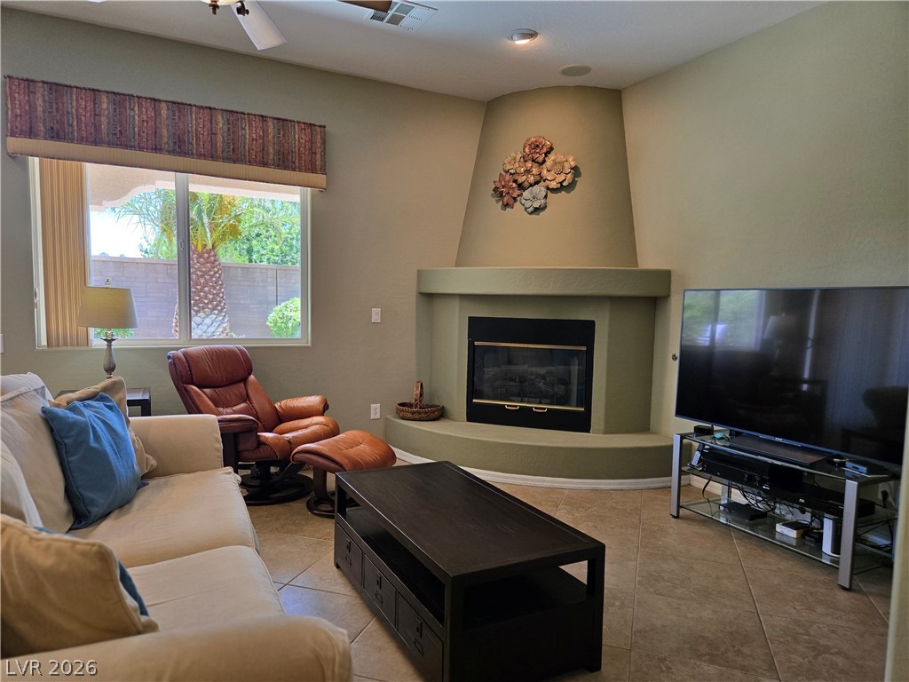 2567 Dirleton Place Henderson, NV 89044 - Photo 23 of 67 A corner fireplace and large window illuminate this inviting living room.