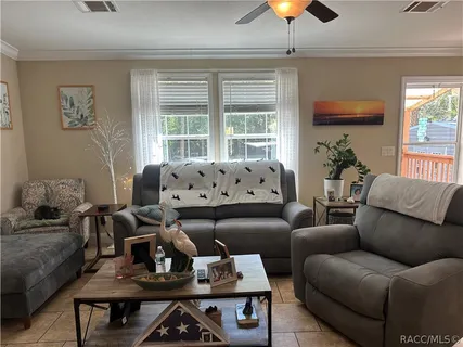 a living room with furniture and a chandelier