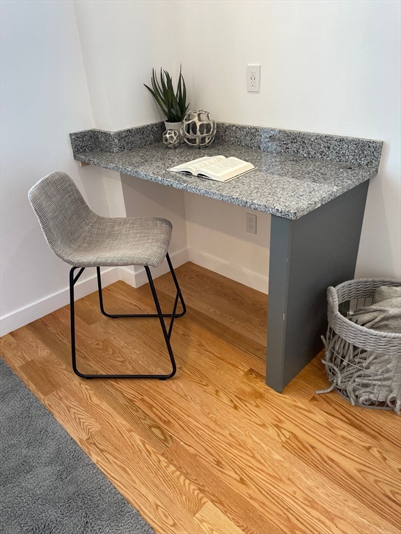 64 Market Street, Unit 506 Lynn, MA 01901 - Photo 4 of 7 a room with table chairs and wooden floor