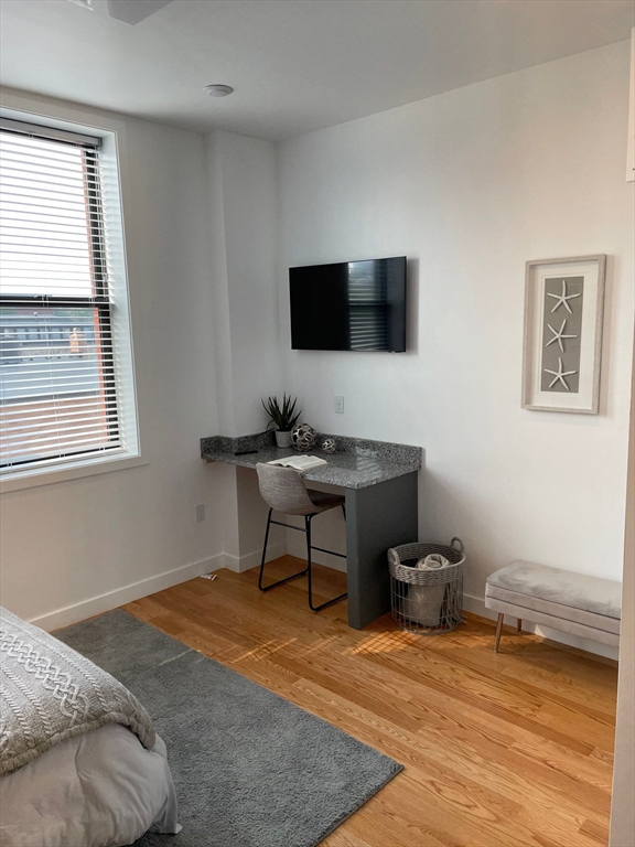 64 Market Street, Unit 506 Lynn, MA 01901 - Photo 6 of 7 a bedroom with furniture and a window