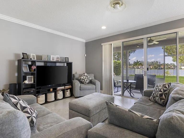 7782 Hoffy Circle Lake Worth, FL 33467 - Photo 12 of 27 a living room with furniture and a flat screen tv