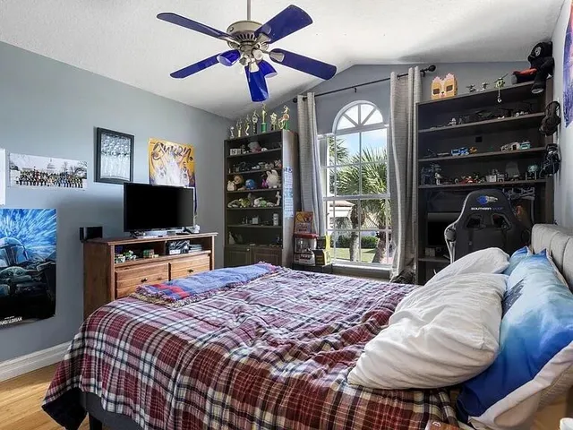 a bedroom with a bed and a flat screen tv