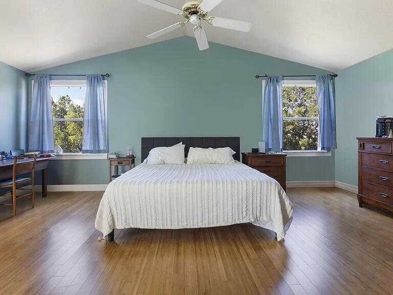 7782 Hoffy Circle Lake Worth, FL 33467 - Photo 18 of 27 a bedroom with a bed a table and a window