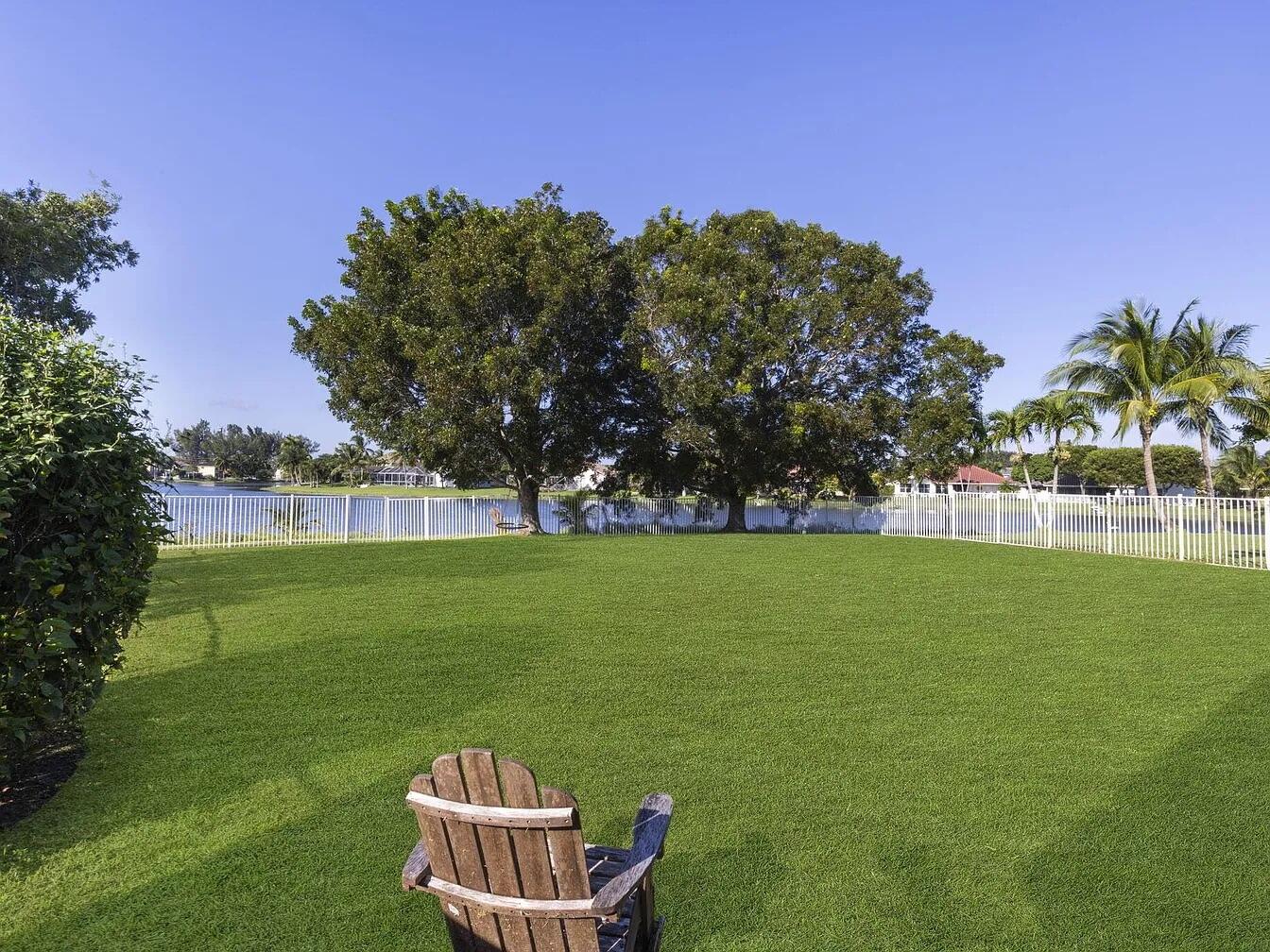 7782 Hoffy Circle Lake Worth, FL 33467 - Photo 2 of 27 a view of a green field with trees in the background