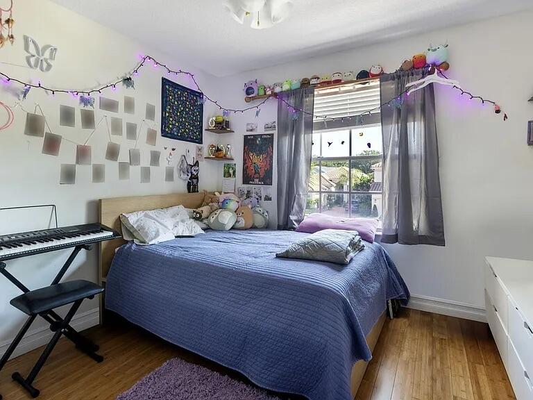 7782 Hoffy Circle Lake Worth, FL 33467 - Photo 21 of 27 a bedroom with a bed and wooden floor