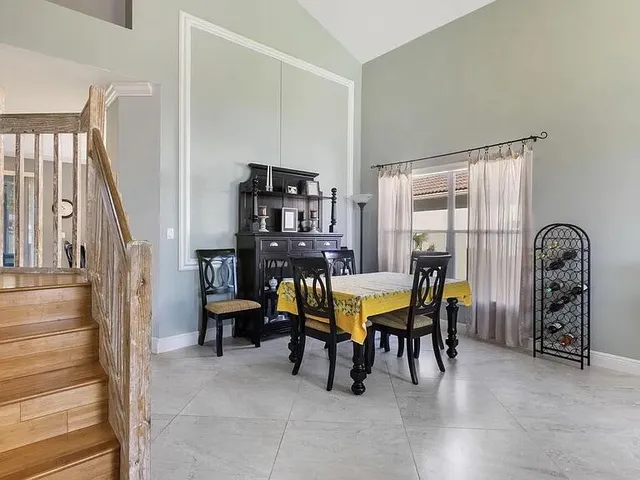 a view of a dining room with furniture and a window