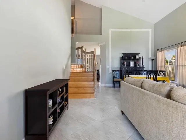 a living room with furniture and a dining table