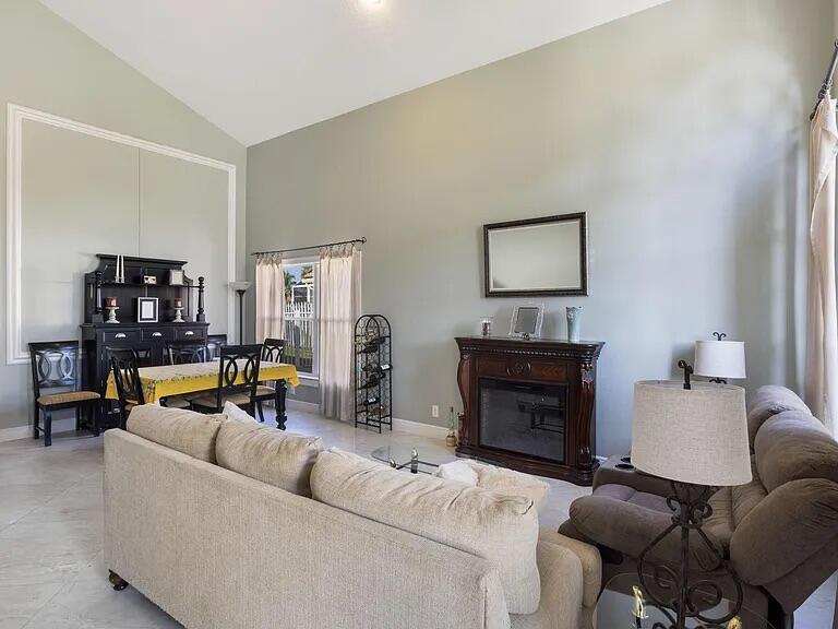 7782 Hoffy Circle Lake Worth, FL 33467 - Photo 27 of 27 a living room with furniture and a fireplace