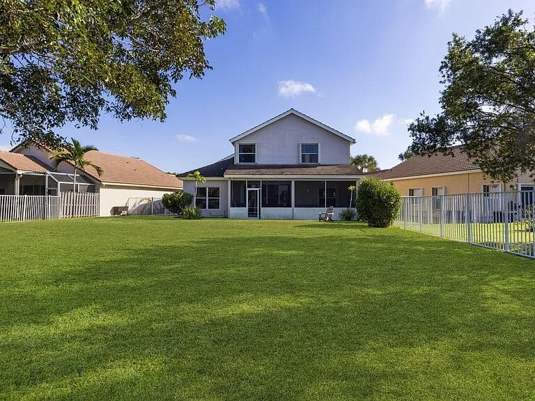 7782 Hoffy Circle Lake Worth, FL 33467 - Photo 3 of 27 a front view of a house with a garden