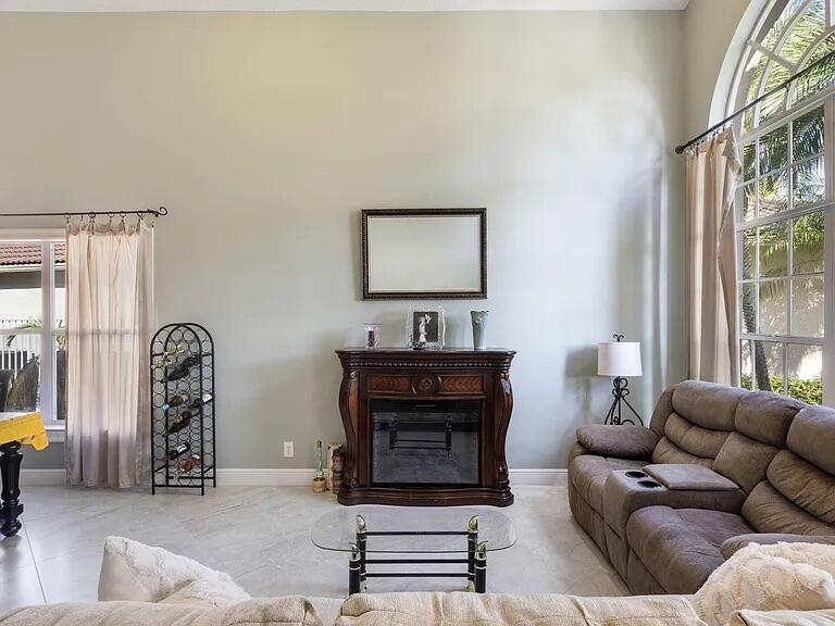 7782 Hoffy Circle Lake Worth, FL 33467 - Photo 6 of 27 a living room with furniture a lamp and a window