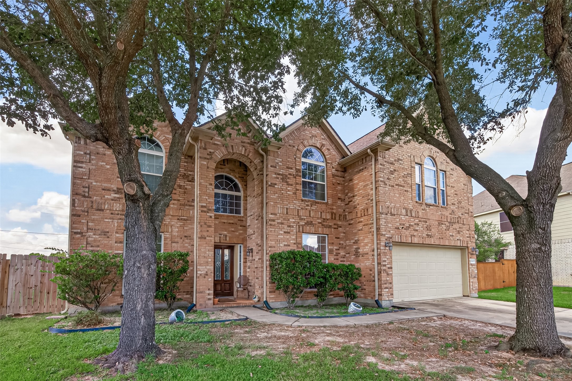 22007 Bridgestone Hawk Court Spring, TX 77388 - Photo 3 of 50 Large arched windows accentuate the facade, with a towering archway that frames the front door.