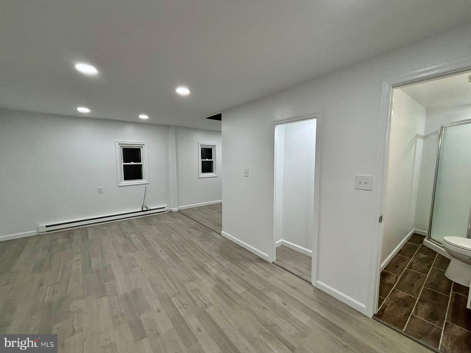 218 Elm Street Steelton, PA 17113 - Photo 13 of 22 an empty room with wooden floor and windows