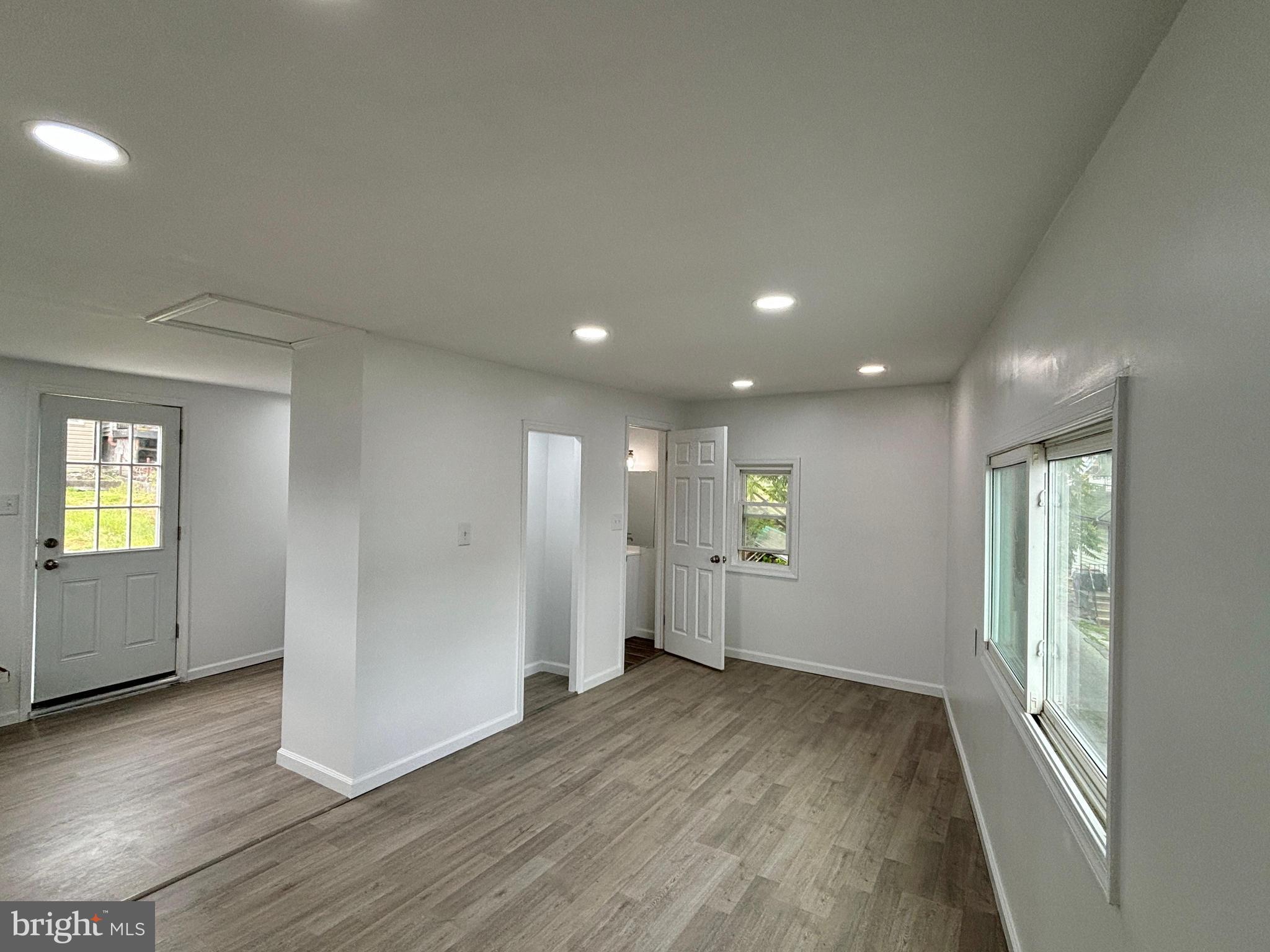 218 Elm Street Steelton, PA 17113 - Photo 17 of 22 an empty room with wooden floor and windows