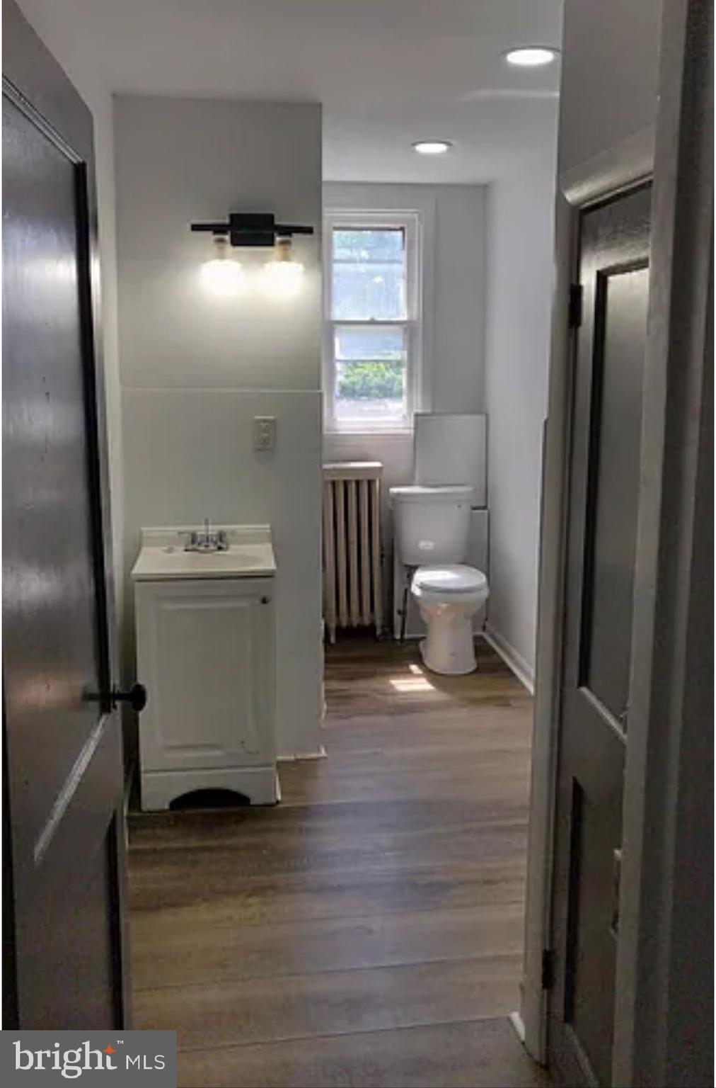 218 Elm Street Steelton, PA 17113 - Photo 5 of 22 a bathroom with a sink a toilet and a large mirror