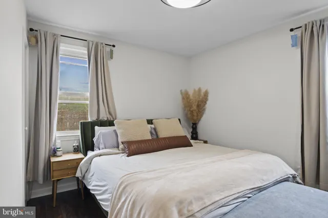 a bedroom with a large bed and a large window