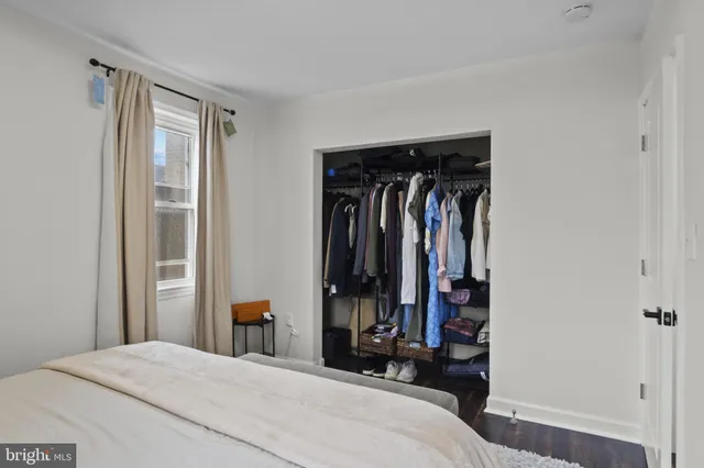 a bed room with a bed and walk in closet