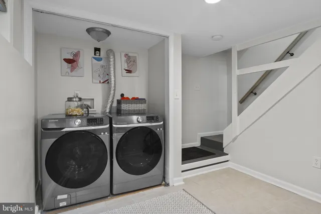 a view of a storage and utility room with washer and dryer