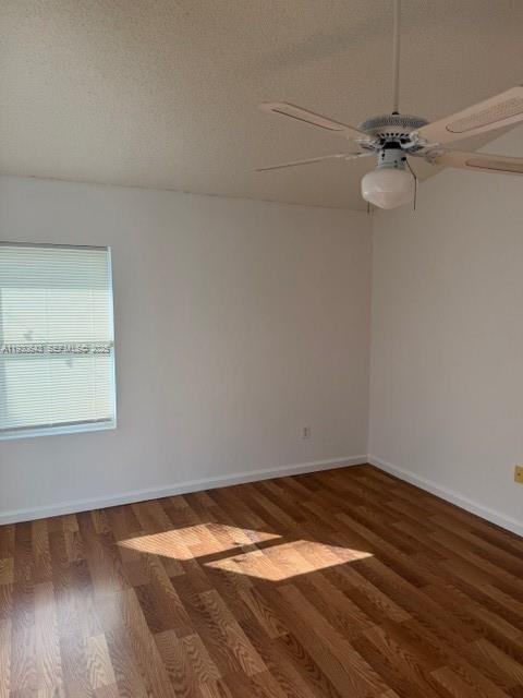 14624 Southwest 143rd Pl Circle Miami, FL 33186 - Photo 6 of 13 a view of a room with wooden floor and white walls