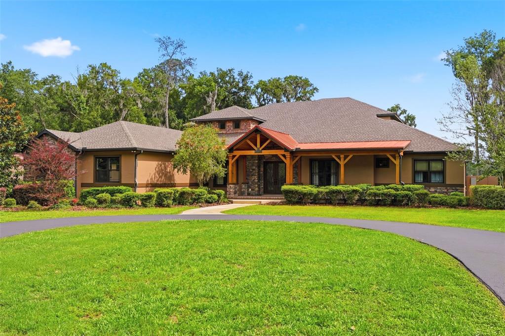 855 Southeast 87th Street Ocala, FL 34480 - Photo 1 of 79 a front view of a house with a yard table and chairs