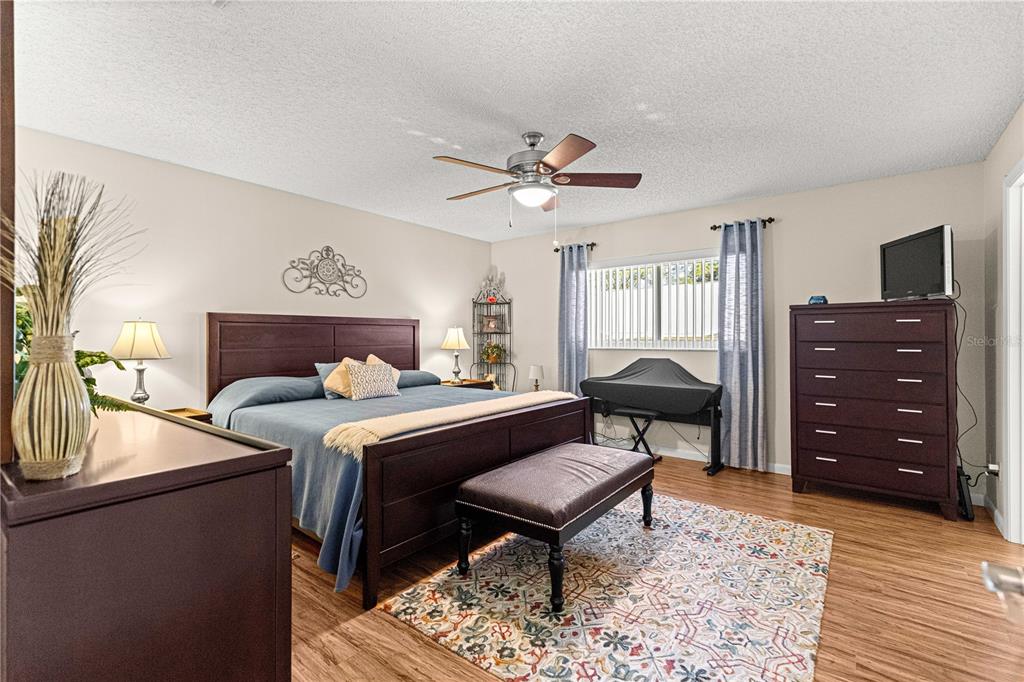 8431 Southwest 93rd Place, Unit G Ocala, FL 34481 - Photo 18 of 50 a bedroom with a bed and a dresser in it