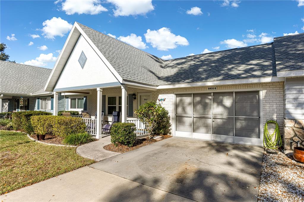 8431 Southwest 93rd Place, Unit G Ocala, FL 34481 - Photo 2 of 50 a front view of a house with a yard
