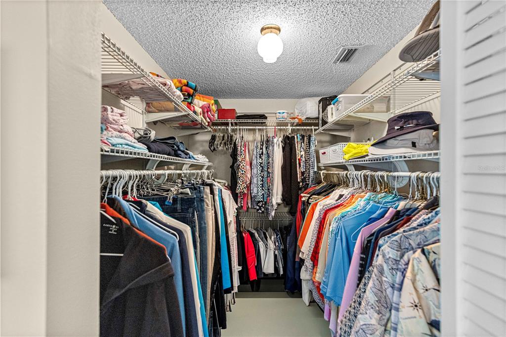 8431 Southwest 93rd Place, Unit G Ocala, FL 34481 - Photo 23 of 50 a view of walk in closet with clothes and shoes