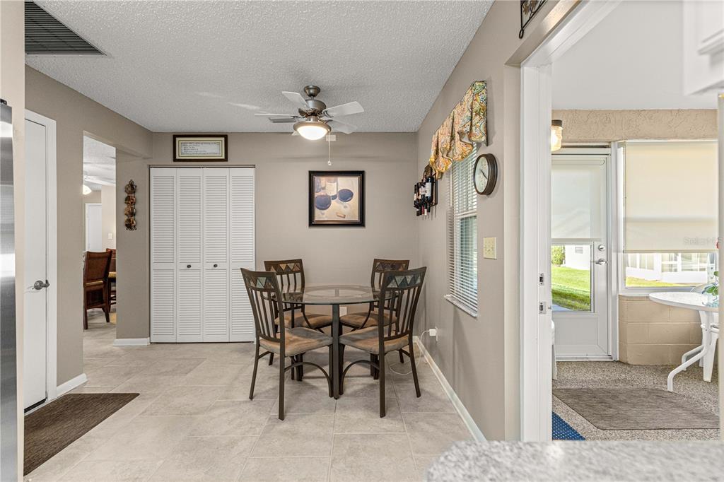 8431 Southwest 93rd Place, Unit G Ocala, FL 34481 - Photo 28 of 50 a view of a dining room with furniture and a chandelier