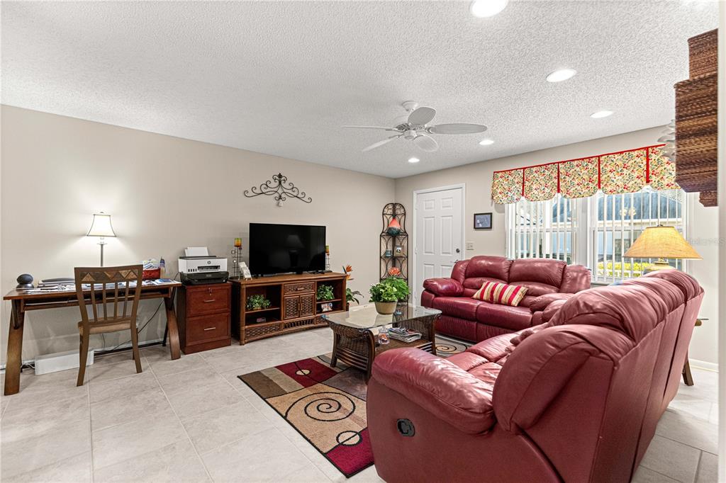 8431 Southwest 93rd Place, Unit G Ocala, FL 34481 - Photo 10 of 50 a living room with furniture and a flat screen tv